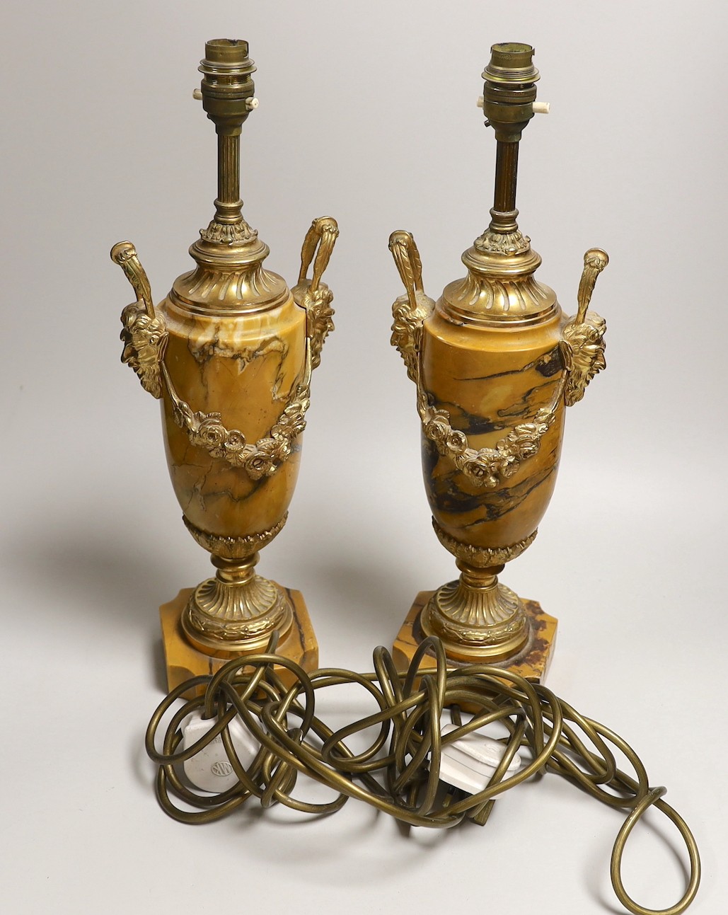 A pair of neo classical revival gilt metal and Siena marble lamps, 43cms high including light fitting